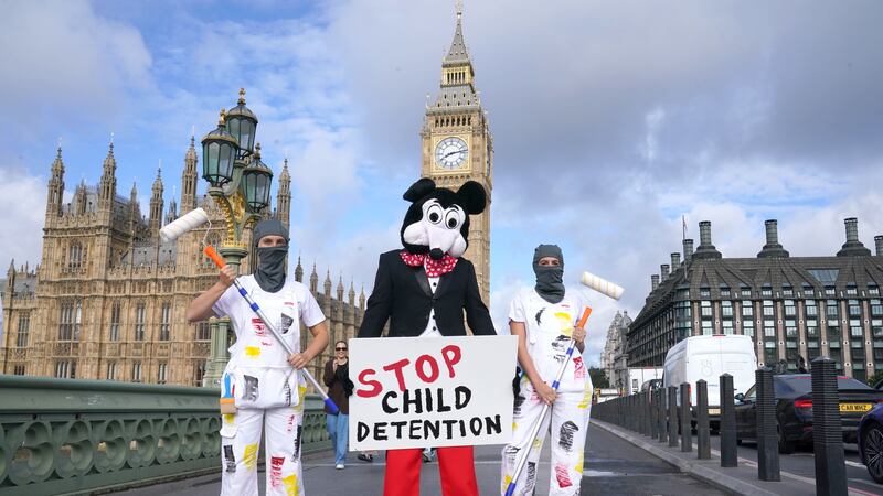 Dom Joly, dressed as Mickey Mouse, leads the protest (Lucy North/PA)
