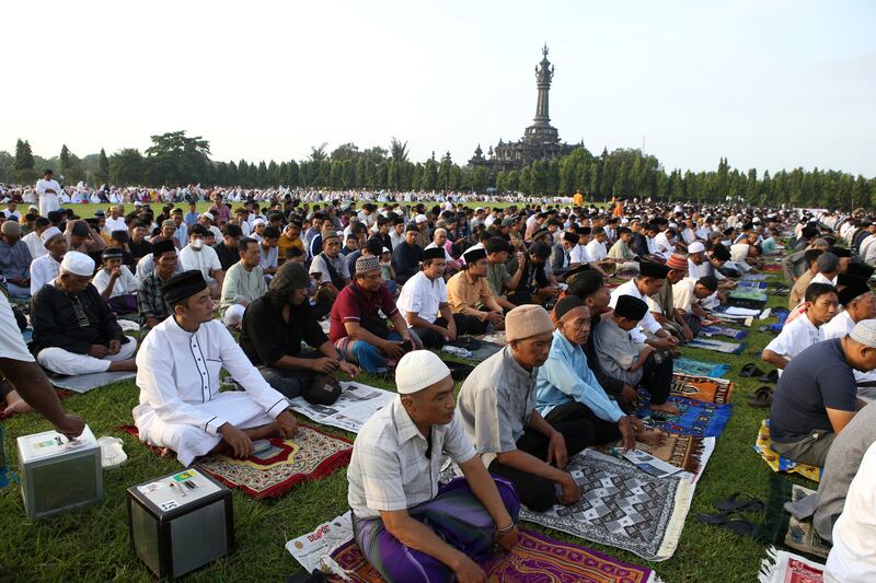 Muslims perform prayers marking the end of the holy fasting month of Ramadan at a field in Bali (Firdia Lisnawati/AP)