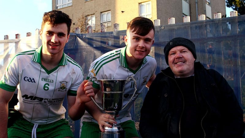 Burren&rsquo;s joint captains Conor Cox (left) and Darragh Murdock accept the Jimmy McConville Cup from St Paul&rsquo;s and former Antrim stalwart Anto Finnegan after  winning the Ulster Club Minor Tournament at St Paul GAC, Belfast. Picture Seamus Loughran.&nbsp;