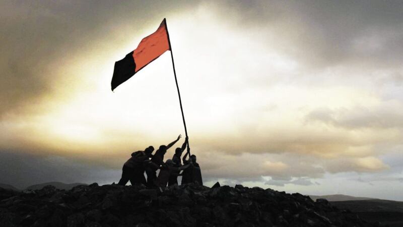 Fans from the Kingdom of Mourne scale the summit of Eden Trumley in the |Mourne Mountains, to erect their Down county colours ahead of the 2010 All-Ireland Senior Football Championship final challenge against Cork in Croke Park, Dublin. Picture by Mark Pearce  