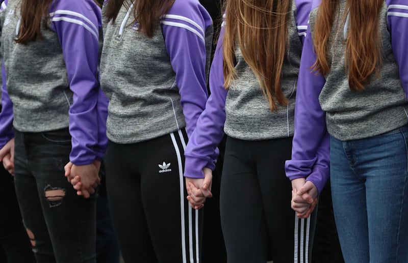 &nbsp;Lauren Bullock's cheerleading friends hold hands as they form a guard of honour. Picture by Liam McBurney, PA Wire