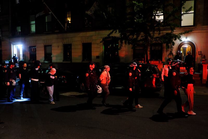 Members of the New York Police Department strategic response team escort protesters from Columbia University (Julius Motal/AP)