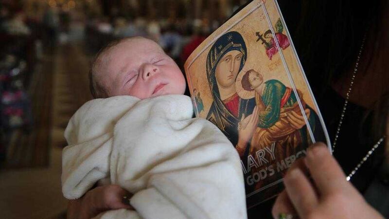 Three-week-old Freddie McMullan pictured on the first day of the Clonard Novena yesterday. Picture by Hugh Russell 