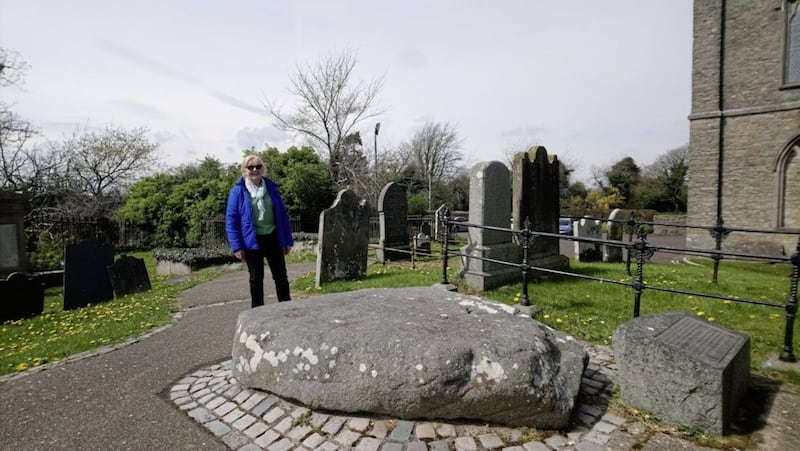 Brigid Watson at the grave of St Brigid at Down Cathedral in Downpatrick. She is buried alongside St Patrick and St Colmcille. 