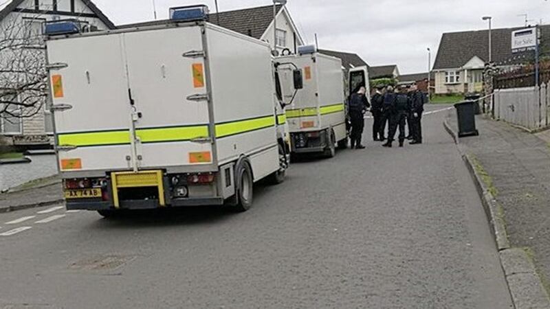 Army bomb disposal examine a device in the Farmhill area of Foyle Springs in Derry. 