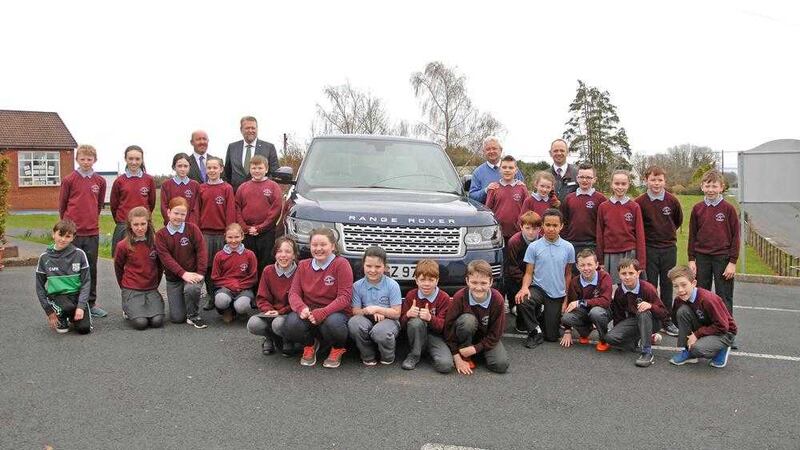 Principal Stephen Baine, Charles Hurst&#39;s Lars-Erik Aaroy, VP Paul McKernan and Jason O&#39;Neill from Charles Hurst with P7 pupils. Picture by Conal Brolly 