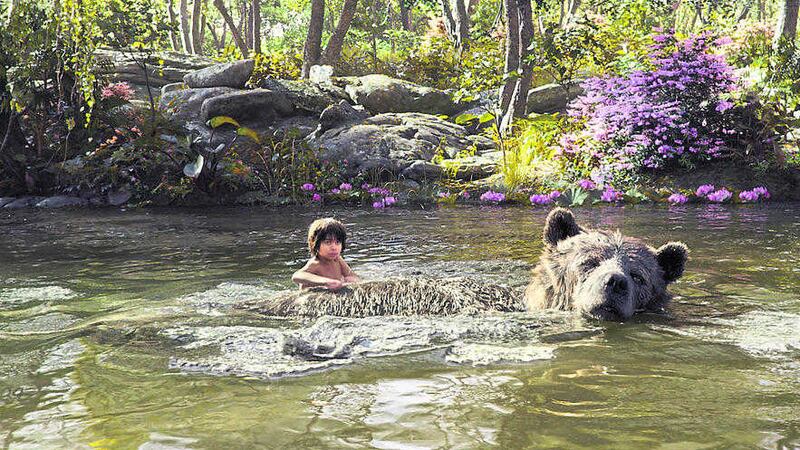 Neel Sethi as Mowgli, below with Baloo the bear (voiced by Bill Murray), in The Jungle Book 