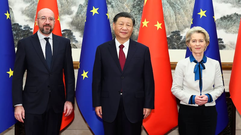 Chinese President Xi Jinping, centre, stands for a group photograph with European Commission president Ursula von der Leyen, right, and European Council president Charles Michel prior to their meeting at the Diaoyutai State Guesthouse in Beijing (Huang Jingwen/Xinhua via AP)