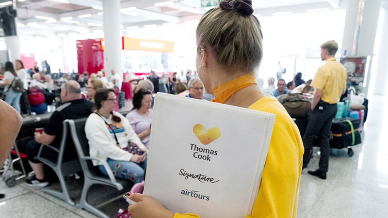 Thomas Cook staff give information to passengers at Palma de Mallorca airport following the collapse of the company&nbsp;