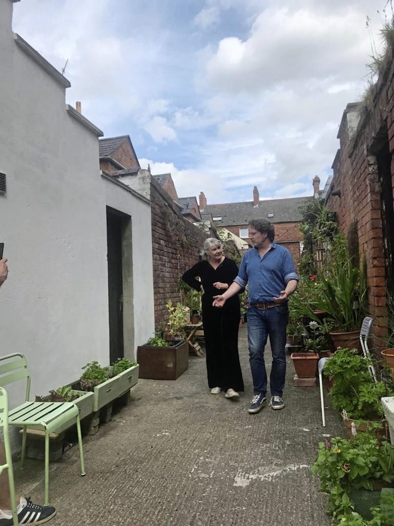 Irish gardening expert Diarmuid Gavin (left) pictured on Wednesday at the famous blooming alley in south Belfast with resident, Bridget Loughran. Picture: Roisin Davis 