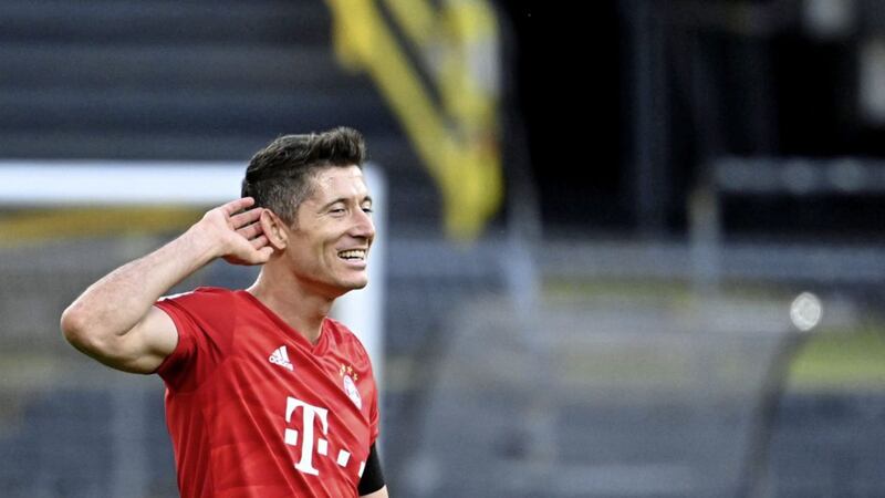 Munich&#39;s Robert Lewandowski reacts after the German Bundesliga soccer match between Borussia Dortmund and FC Bayern Munich in Dortmund, Germany, Tuesday, May 26, 2020. The German Bundesliga is the world&#39;s first major soccer league to resume after a two-month suspension because of the coronavirus pandemic. (Federico Gambarini/DPA via AP, Pool). 
