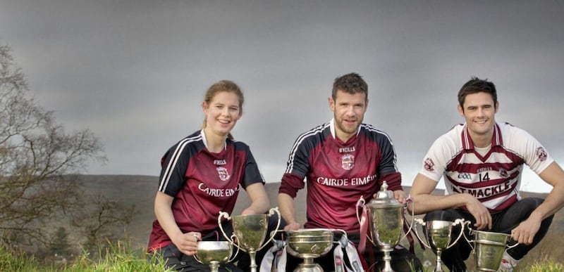 Slaughtneil captains Aoife N&iacute; Chaiside, Francis McEldowney and Chrissy McKaigue with the recently collected silverware