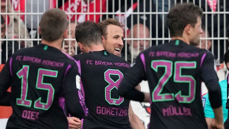 Harry Kane is congratulated by team-mates after scoring for Bayern Munich (Ebrahim Noroozi/AP)