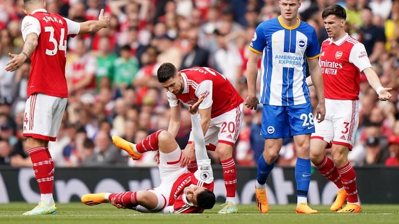Arsenal lost Gabriel Martinelli (grounded) in the first half (Tim Goode/PA)