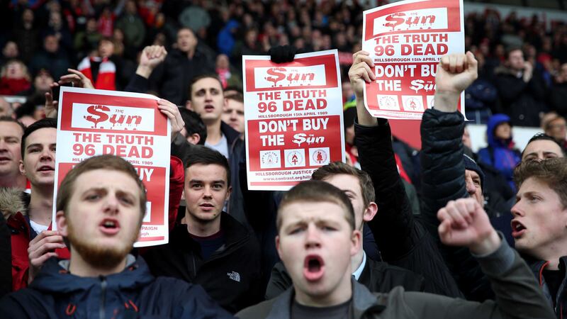 In the aftermath of the Hillsborough inquest verdict, Liverpool fans hold up signs protesting against the Sun newspaper during the Barclays Premier League match Swansea at the Liberty Stadium on Sunday<br />Picture by PA&nbsp;