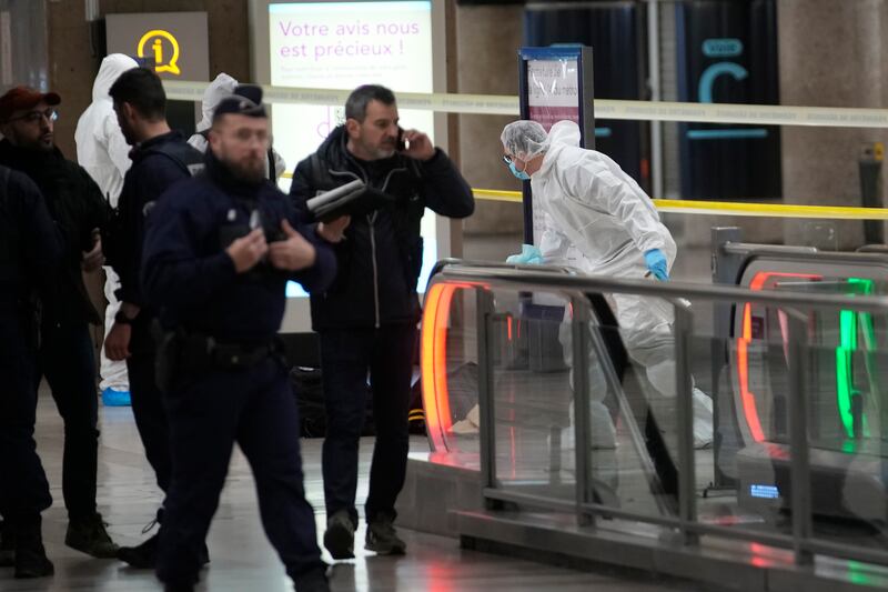 Investigators work inside the Gare de Lyon station following the attack (AP)