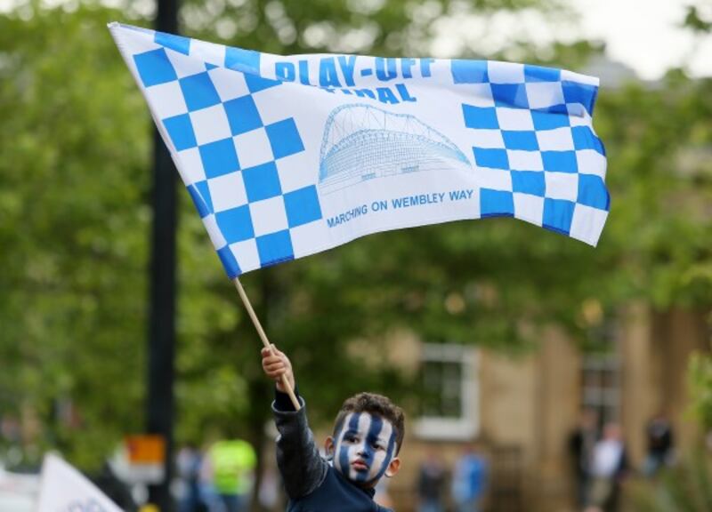 A young fan ahead of Huddersfield Town's promotion parade in Huddersfield town centre
