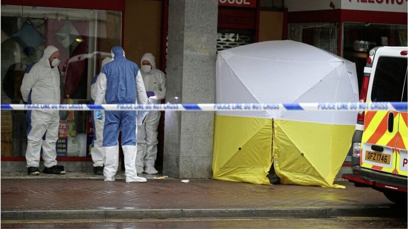 Police and forensic officers at the scene on High Street in Belfast city centre where a homeless man died in a shop doorway. Picture by Hugh Russell 