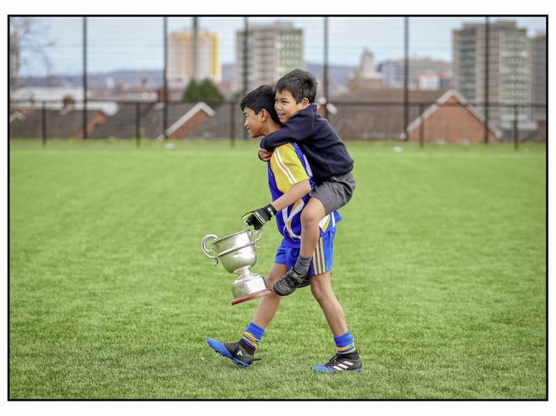 St Brides pupils Techin and Natthawut McGarvey carry the Raffo Cup after their school won the Cumann na mBunscoil A League Final in Belfast Picture Mal McCann. 