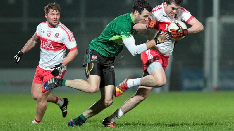 Derry's Shane McGahon gets away from Henry Brown of Queen's during Wednesday night's McKenna Cup match at Celtic Park <br />Picture by Margaret McLaughlin&nbsp;