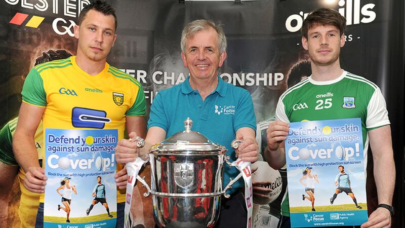Gerry McElwee,head of cancer prevention at Cancer Focus, flanked by Paul Brennan (Donegal) and Tom&aacute;s Corrigan (Fermanagh) - was delighted to get the chance to hold the cup ahead of Sunday&rsquo;s final between the two teams, while dishing out advice on safety in the sun 