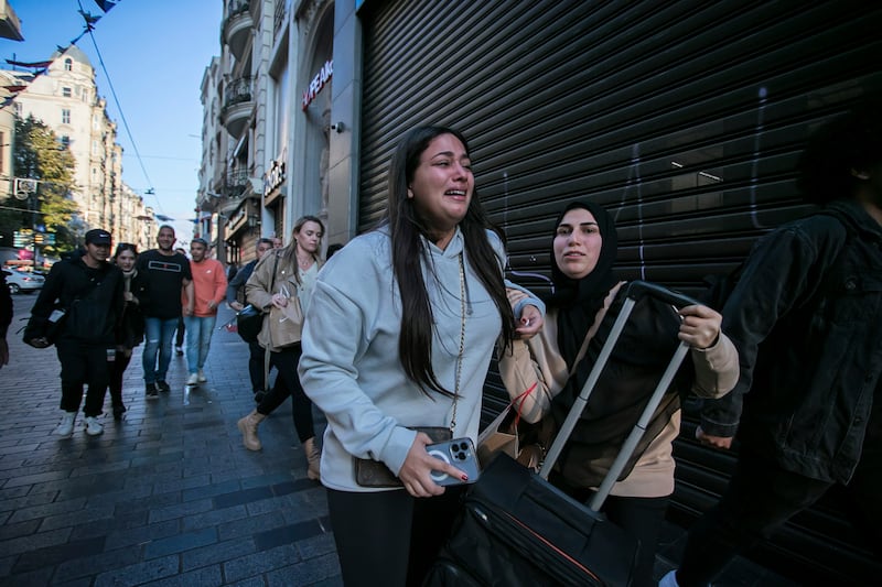 People leave the area after an explosion on Istanbul’s popular pedestrian Istiklal Avenue in 2022 (Can Ozer/AP)