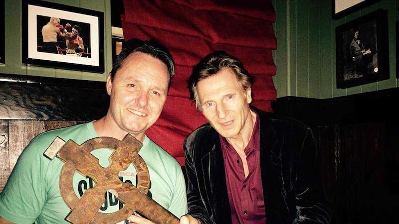 Sean Muldoon, co-owner of The Dead Rabbit in New York, with actor Liam Neeson and the cross from Gangs of New York. Picture from The Dead Rabbit/Facebook&nbsp;