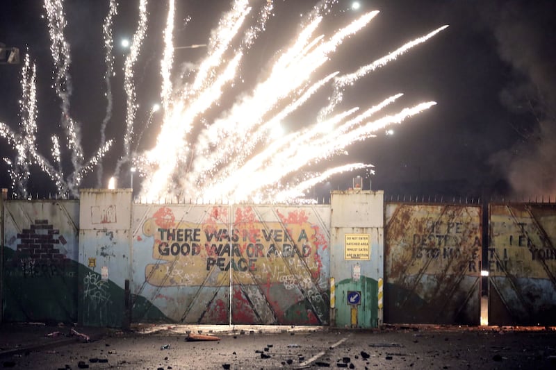 A firework explodes as republicans and loyalists clash with one another at the peace wall on Lanark Way in west Belfast on April 7 2021.  Picture by AP Photo/Peter Morrison