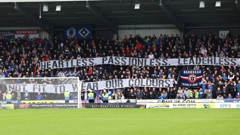 Rangers fan holds up a large banner saying ‘Heartless. Passionless. Leaderless. Not Fit To Wear Our Colours’ (Robert Perry/PA)
