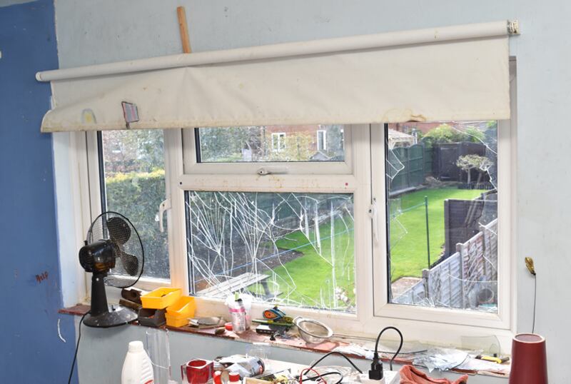A damaged window after an explosion in Matthew Haydon’s home laboratory