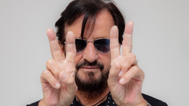 The gesture is the former Beatles drummer’s signature greeting and symbolises his message of ‘positivity and light’ to the world.