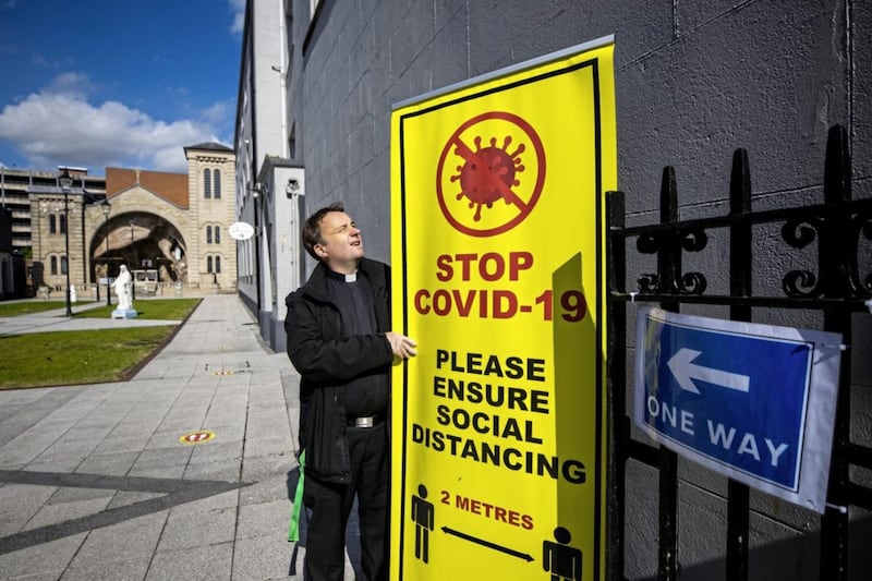 Social distancing and health measures must be clearly communicated when churches reopen for public worship. Fr Tim Bartlett, administrator of St Mary&#39;s, Chapel Lane, with signs installed when private prayer was reintroduced last month. Picture by Liam McBurney/PA Wire 