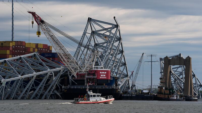 The collapsed Francis Scott Key Bridge lays on top of the container ship Dali (AP Photo/Matt Rourke)