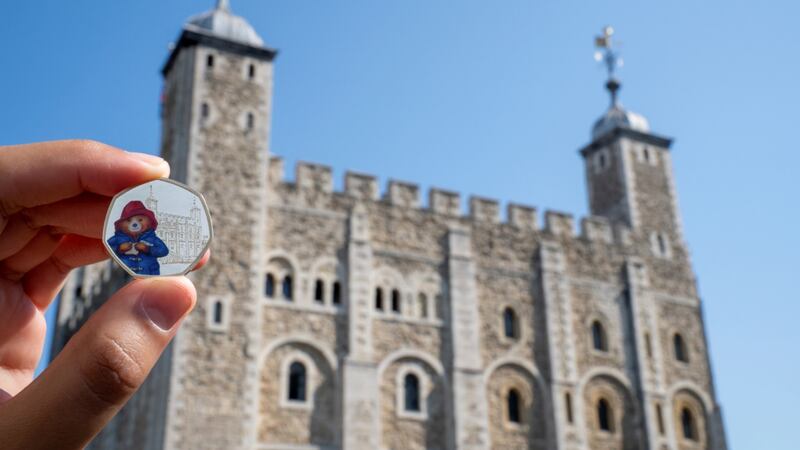 The coins depict Paddington Bear visiting the Tower of London and St Paul’s Cathedral in London.