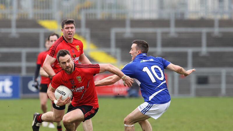 Down&#39;s Mark Poland wrong-foots Laois&#39; Niall Donoher during NFL match at Pairc Esler 