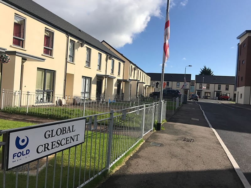 Until today, flags were flying from lamp posts in neighbouring Global Crescent which is also a shared housing scheme. Picture by Mal McCann
