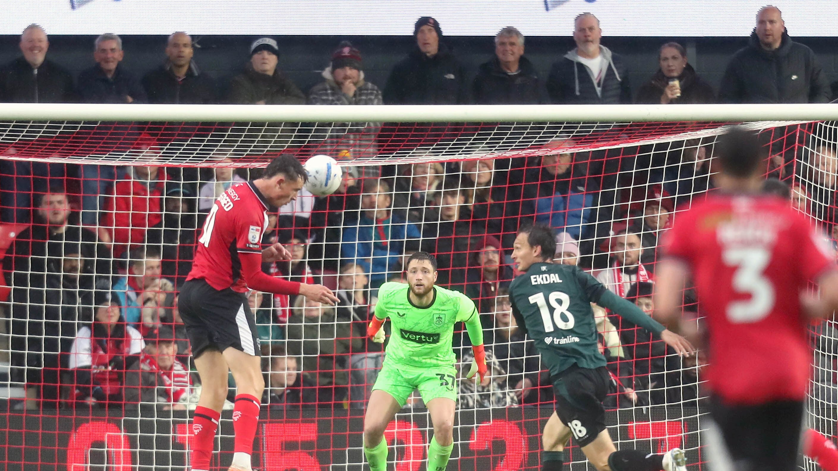 Lincoln City’s Mikkel Ladefoged (left) scores his sides fourth goal against Burnley