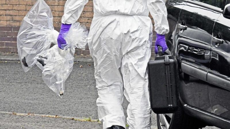 A forensic officer examines the scene of a blast bomb attack at Clandeboye Gardens in the Short Strand area in east Belfast on July 11. Photo by Alan Lewis/PhotopressBelfast 