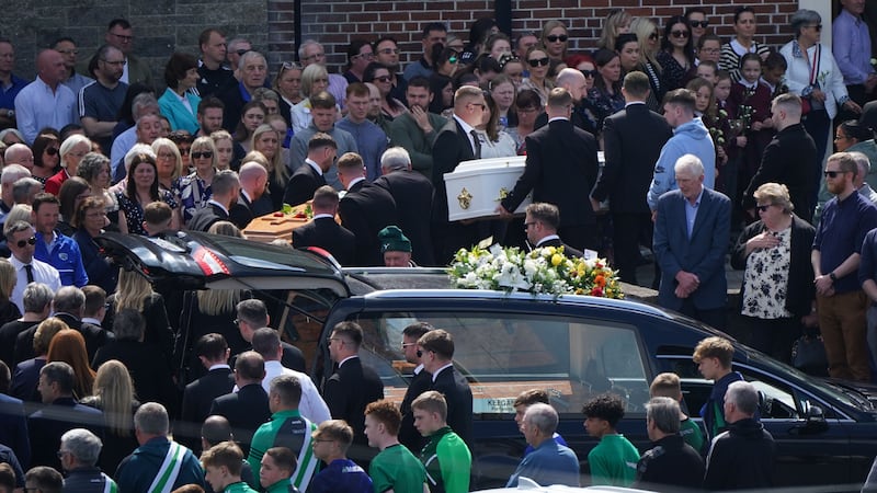 The coffins of father and son Eoin and Dylan Fitzpatrick are carried into their funeral service (Niall Carson/PA)