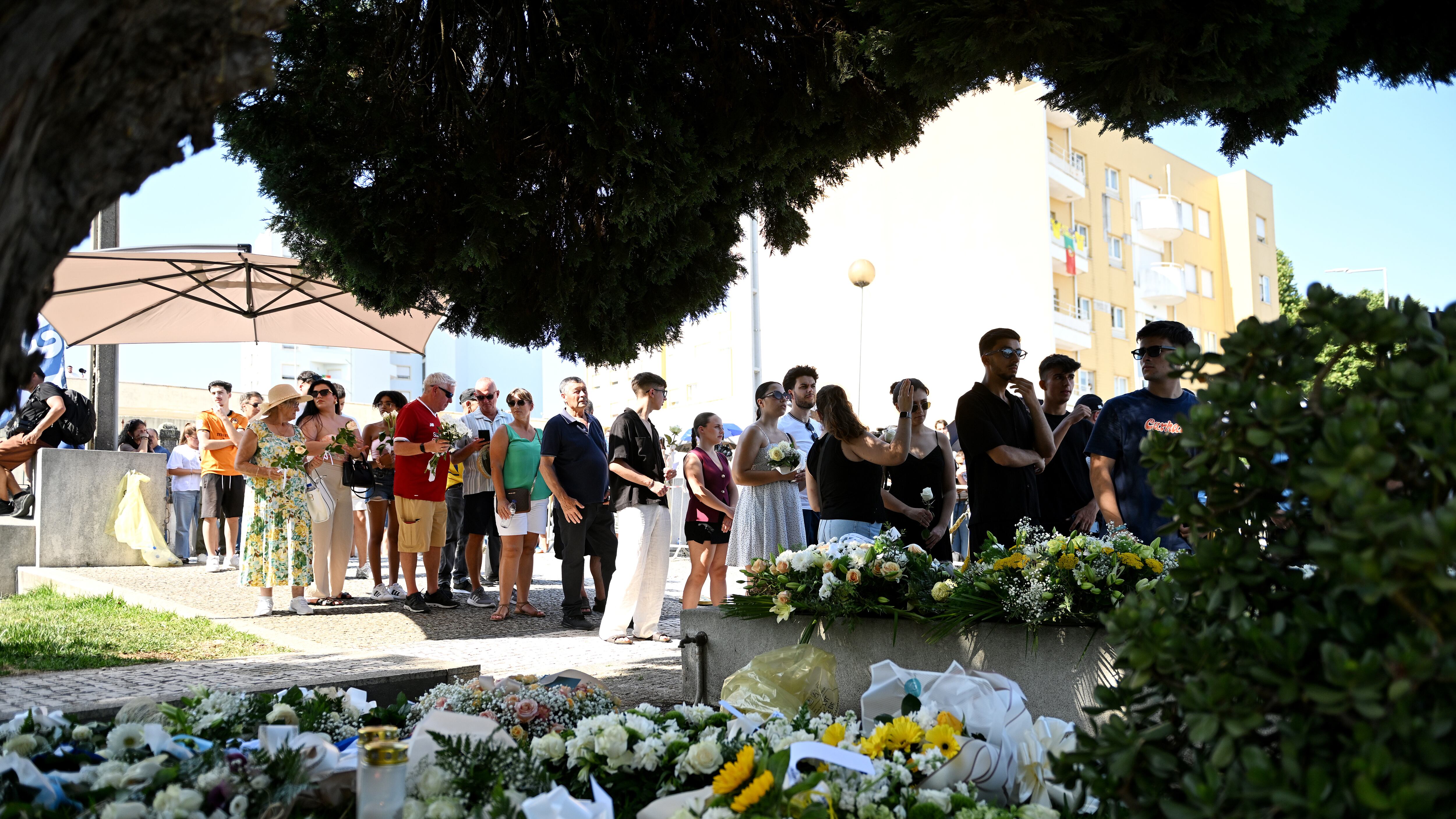 Mourners and floral tributes at the wake of Diogo Jota