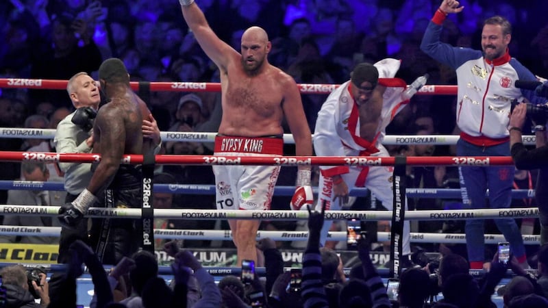 Britain&#39;s Tyson Fury, centre, celebrates after beating Britain&#39;s Dillian Whyte during their WBC heavyweight title boxing fight at Wembley Stadium in April. 