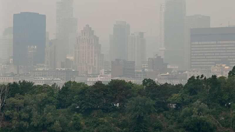 The skyline of Montreal is obscured by a haze of smog (Graham Hughes/The Canadian Press via AP)