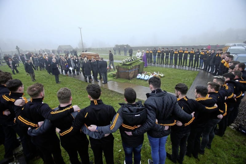 Pomeroy Plunketts GAA members gather around the graveside of Christopher Colhoun. Picture by Mal McCann 