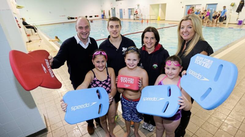 John Crichton, the 7th Earl of Erne and Hope for Youth trustee, swim coach Mark Angus, Tanya Martin, Chair of City of Belfast Swim Club, Hannah English, Elmgrove Primary School teacher and pupils Mia Gribben, Ethan Douglas-Grierson and Miriam Young at the launch of The Ripple Effect water safety initiative 