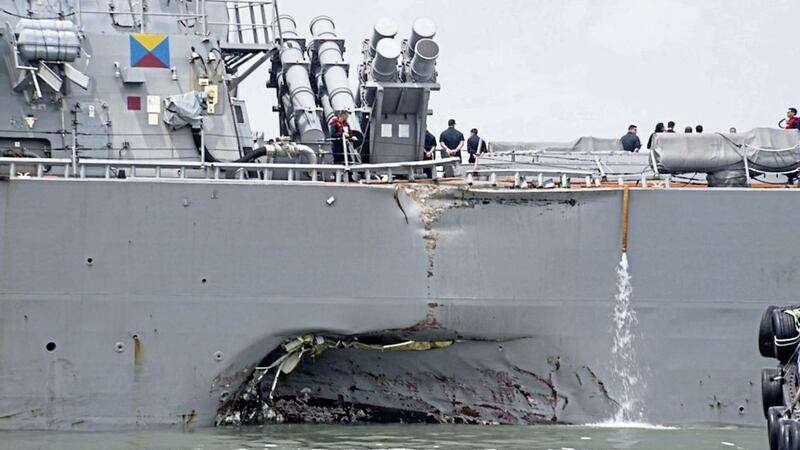 Damage:  A hole in the portside is visible as the guided-missile destroyer USS John S McCain steers towards Changi naval base in Singapore following a collision with the merchant vessel Alnic MC yesterday  PICTURE: Mass Communication Specialist 2nd Class Joshua Fulton/US Navy photo via AP 