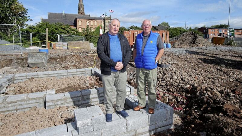 Gerard Brophy of St Patrick&#39;s and St Joseph&#39;s Housing Association and Frank Dempsey pictured as the foundations are laid for a new housing development at Carrick Hill close to Clifton Street Orange Hall, which is in the background. Picture by Mal McCann. 