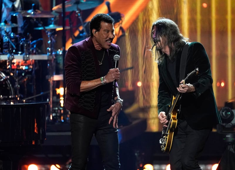 Dave Grohl, right, performs with inductee Lionel Richie during the Rock & Roll Hall of Fame Induction Ceremony at the Microsoft Theatre in Los Angeles