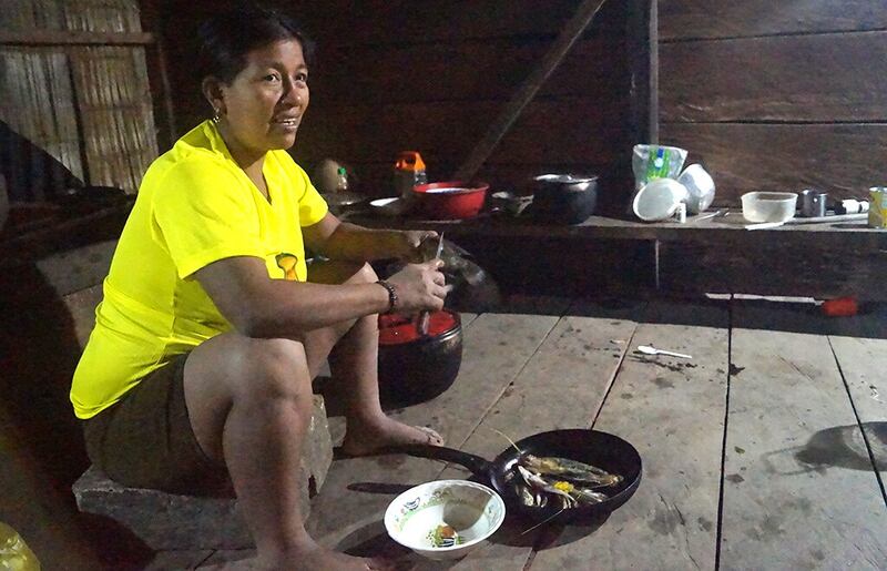 Linda Enqueri cooks at night; before the solar panels arrived she could only cook until 7 pm. Photograph by Emilia Paz y Miño for GK.