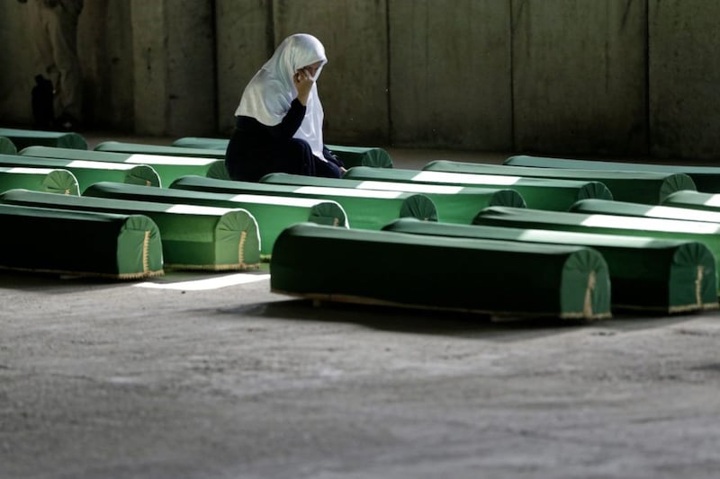 A Bosnian Muslim woman cries near the coffin of her relative among 71 coffins at the memorial centre of Potocari near Srebrenica, 150km north east of Sarajevo, Bosnia,. The coffins were buried on Tuesday. Picture by AP Photo/Amel Emric