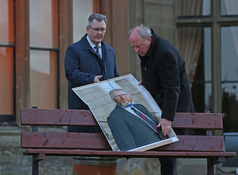 Jim Allister and DUP leader Sir Jeffrey Donaldson remove a poster of the leader of the Ulster Unionist Party, Doug Beattie, with a noose at a rally in Lurgan in April 2022